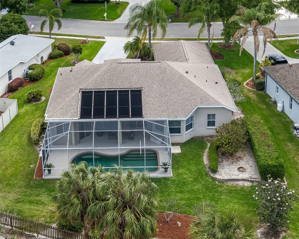 An aerial view of a house with a screened-in pool and solar panels on the roof — 11220 28TH STREET CIRCLE E, PARRISH, FL