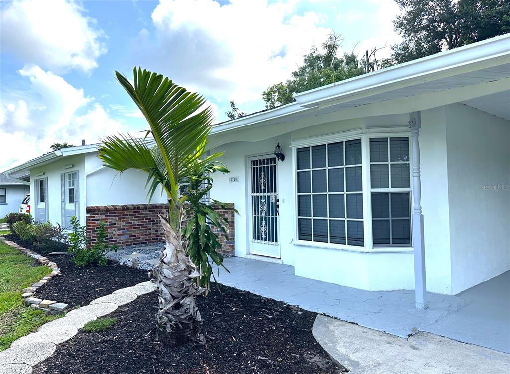 A single-story house with a brick facade, white siding, and an attached carport — 2740 HEATHER PLACE, SARASOTA, FL