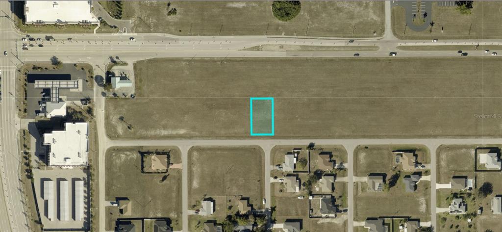 This aerial map shows a vacant rectangular lot highlighted in blue within a residential area — 1713 NE 15TH LANE, CAPE CORAL, FL