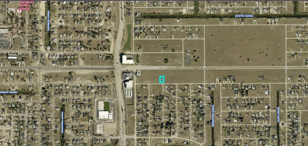 This aerial map shows a vacant residential lot highlighted in blue within a suburban neighborhood — 1713 NE 15TH LANE, CAPE CORAL, FL
