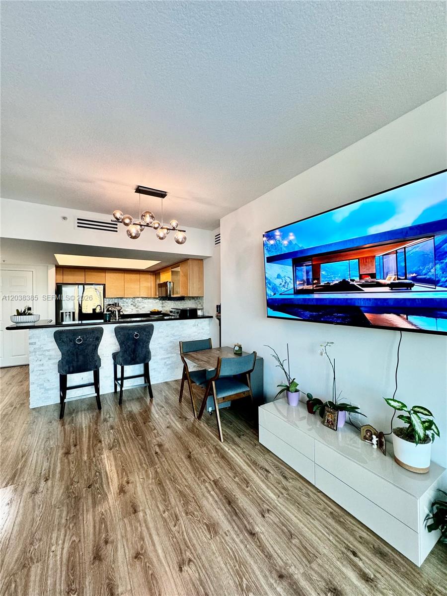 This open-concept living area features a kitchen with a breakfast bar and dining space — 140 S Dixie Hwy # 921, Hollywood FL 33020, HOLLYWOOD, FL