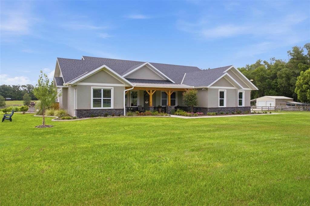 An aerial view of a house with a swimming pool, patio, and large grassy yard — 16241 SE 150TH AVENUE, WEIRSDALE, FL