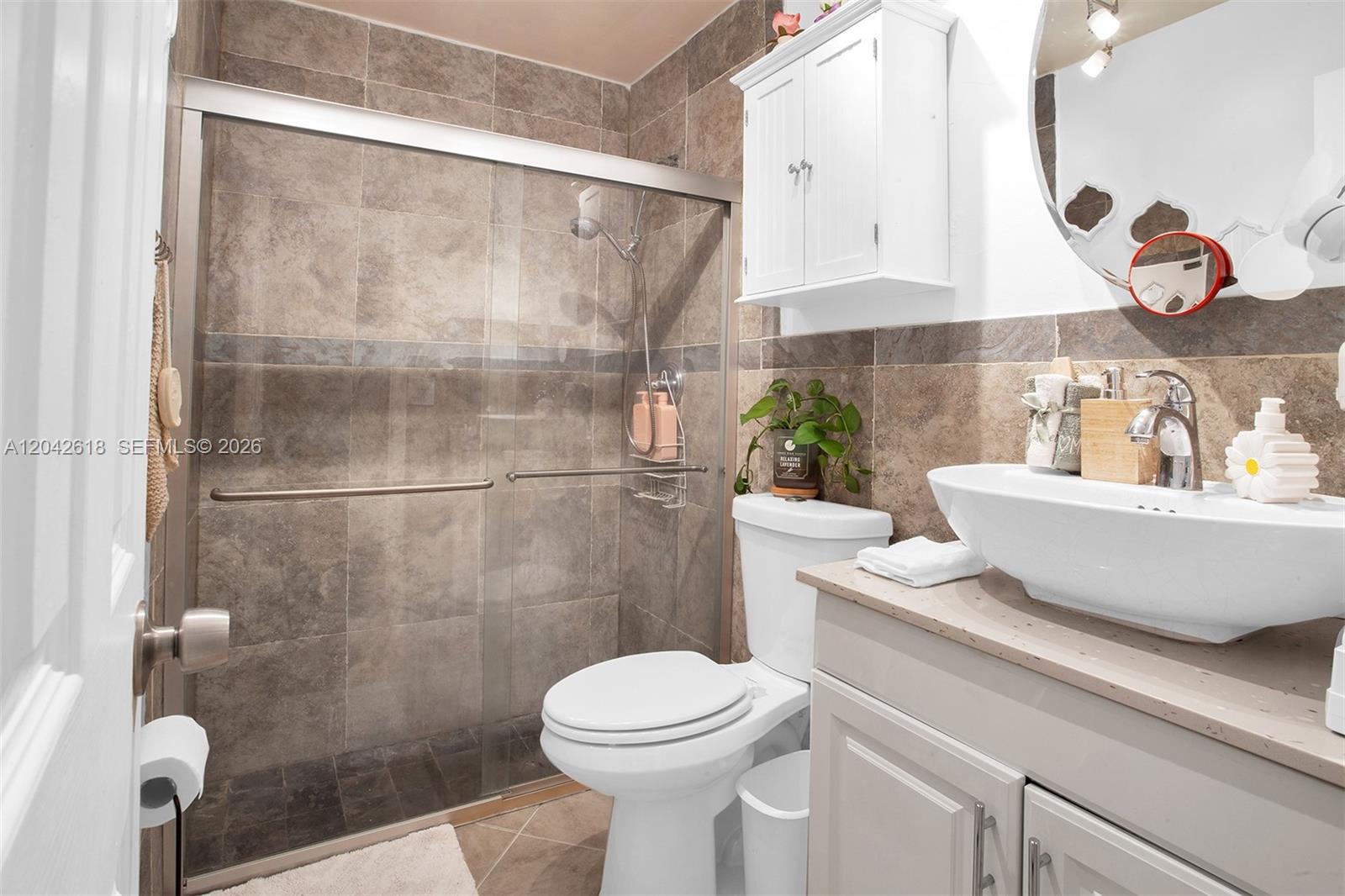 A bathroom features a glass-enclosed shower, a white toilet, and a vessel sink vanity — 9675 NW 26th Pl # 5, Sunrise FL 33322, SUNRISE, FL