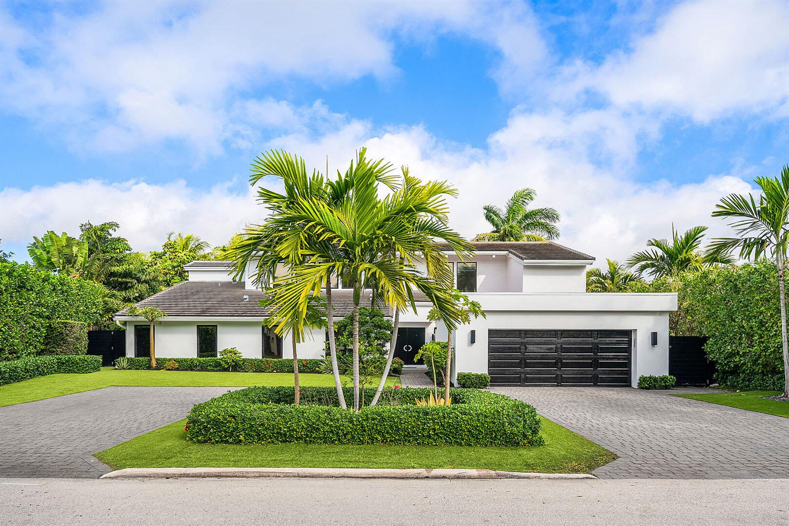 A two-story white house with a black garage door and a palm-filled circular garden — 229 S Maya Palm Drive, Boca Raton FL 33432, BOCA RATON, FL