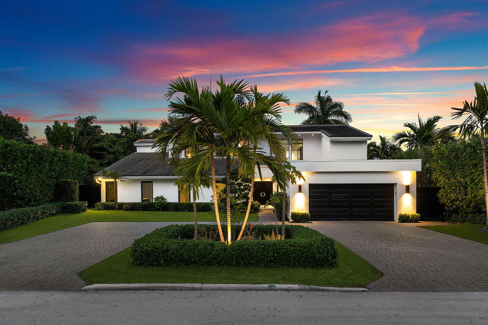 A modern two-story house with a black garage door and a palm tree-centered driveway — 229 S Maya Palm Drive, Boca Raton FL 33432, BOCA RATON, FL