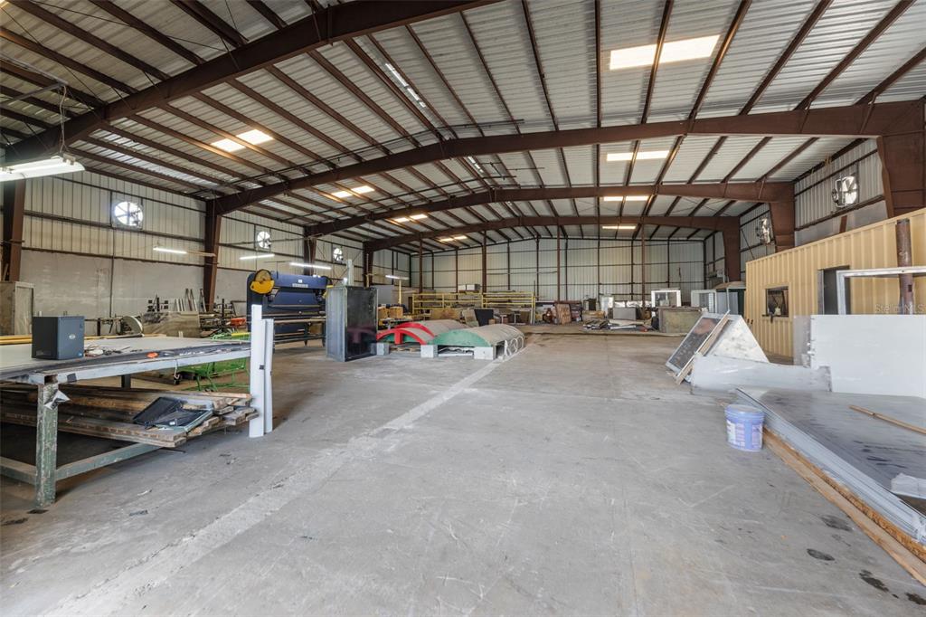 A large industrial warehouse space features a concrete floor, metal walls, and exposed ceiling beams — PR-1 BO RIO SECTOR LOS SANTA UNIT 5, GUAYNABO, PR