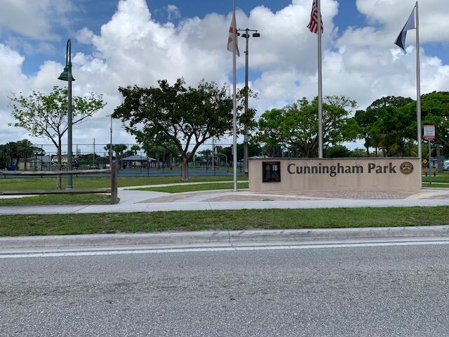 A stone sign for Cunningham Park stands near a street with flags and trees — 2840 Avenue S, West Palm Beach FL 33404, WEST PALM BEACH, FL
