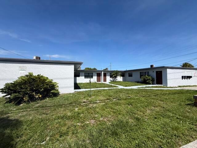 A single-story apartment building with a white stucco exterior and a grassy front yard — 2840 Avenue S, West Palm Beach FL 33404, WEST PALM BEACH, FL
