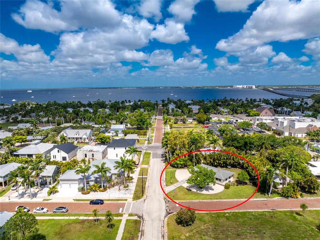 An aerial view shows a single-story house with a circular driveway and surrounding trees — 312 MCGREGOR STREET, PUNTA GORDA, FL