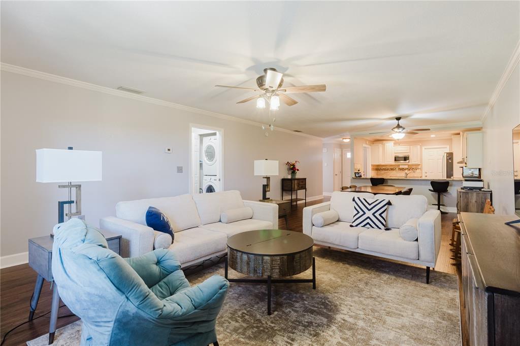 A living room with two sofas, a blue armchair, and an open kitchen in back — 2858 PALO VERDE DRIVE, AVON PARK, FL