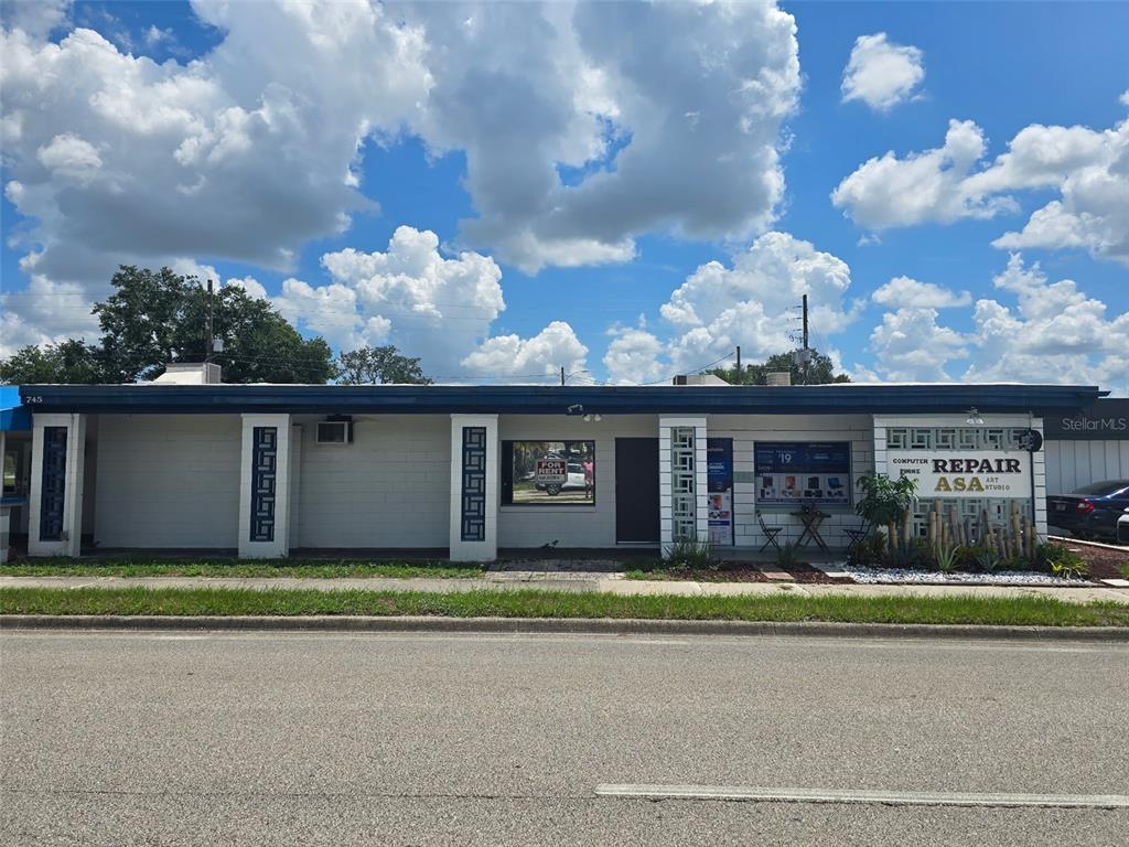 A single-story commercial building with white brick walls, decorative columns, and a flat roof — 741 BENNETT ROAD, ORLANDO, FL