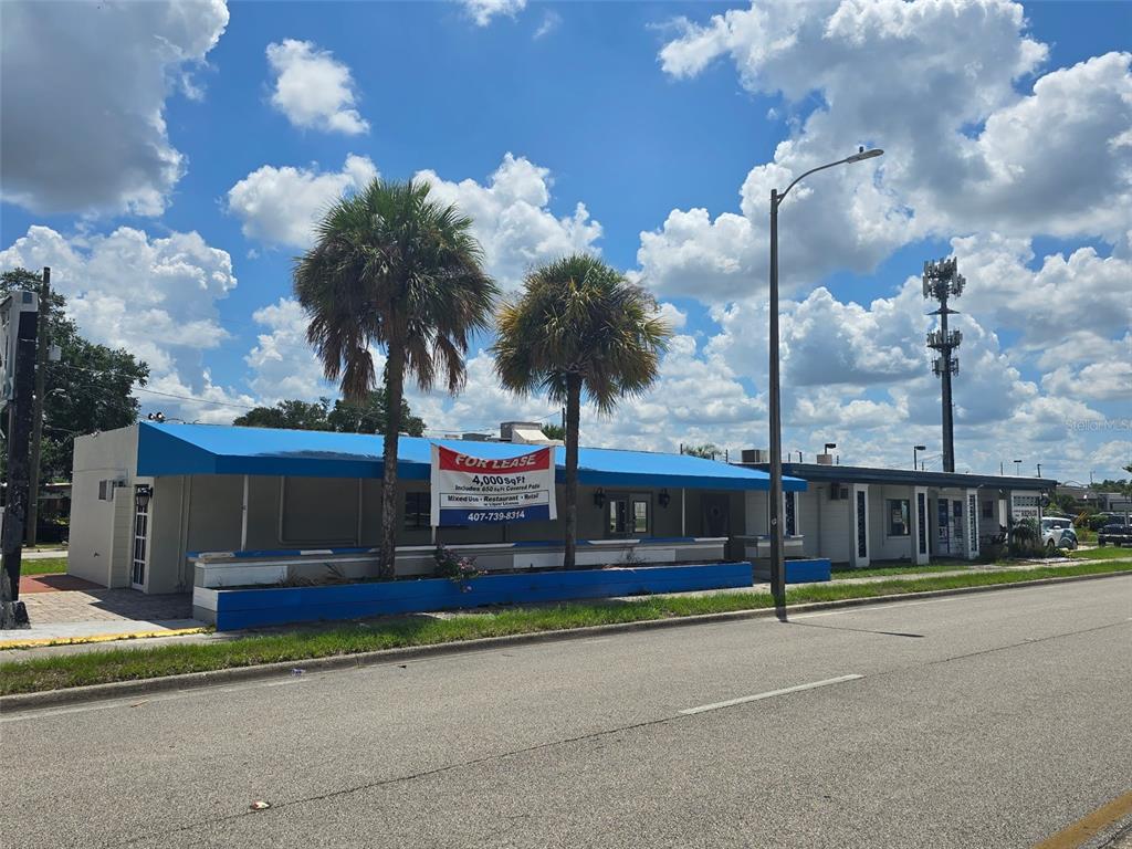 A single-story commercial building with a blue awning and a for lease sign — 741 BENNETT ROAD, ORLANDO, FL