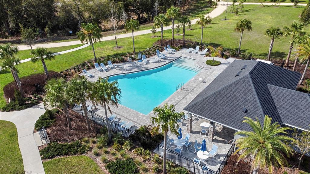 A two-story suburban house with a three-car garage, stone accents, and a paved driveway — 4446 RENLY LANE, CLERMONT, FL