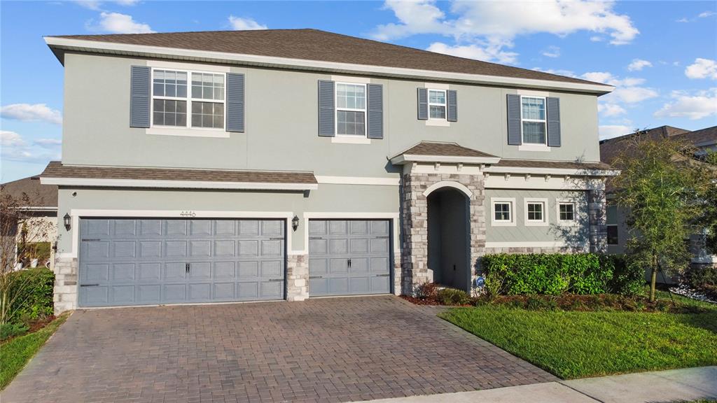 An outdoor swimming pool with a covered patio area and lounge chairs under a blue sky — 4446 RENLY LANE, CLERMONT, FL