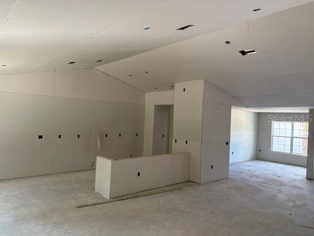 An unfinished room features drywall walls and ceiling with exposed electrical boxes and concrete floors — 17833 SW 61ST LANE ROAD, DUNNELLON, FL