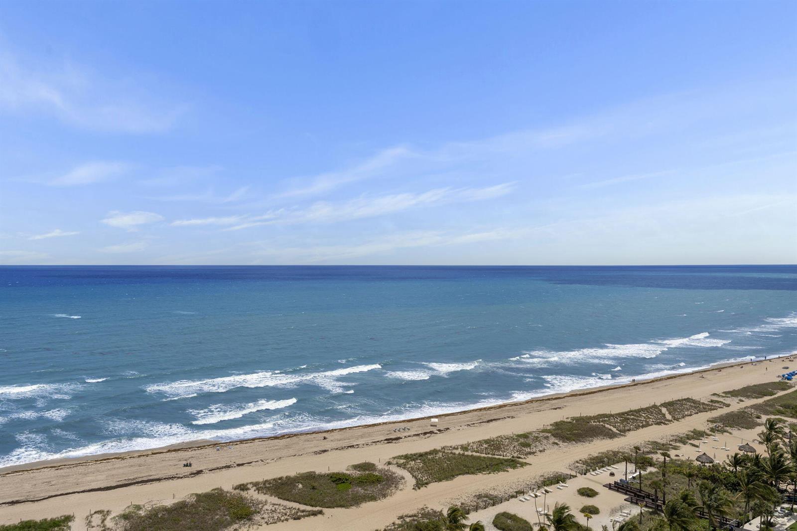 An elevated view of a sandy beach and the ocean under a clear blue sky — 750 N Ocean Boulevard Apt 1904, Pompano Beach FL 33062, POMPANO BEACH, FL