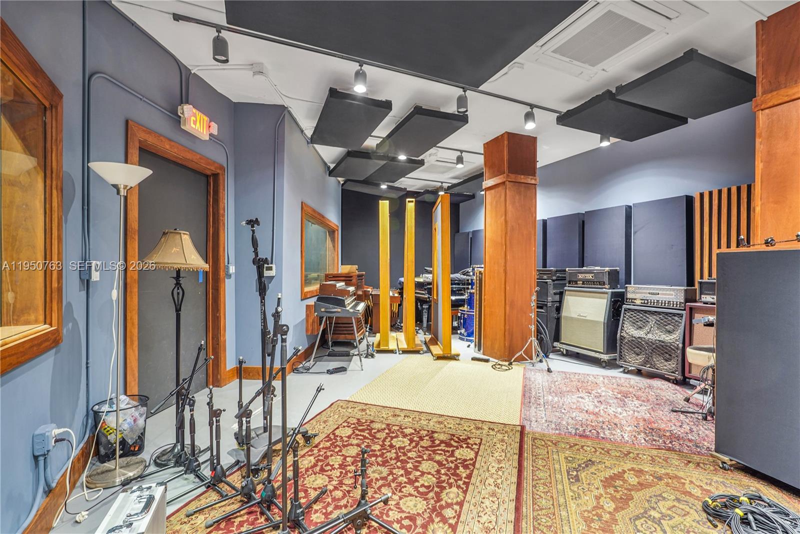 A music recording studio features acoustic ceiling panels, musical instruments, amplifiers, and several area rugs — 1260 NW 29th St, Miami FL 33142, MIAMI, FL