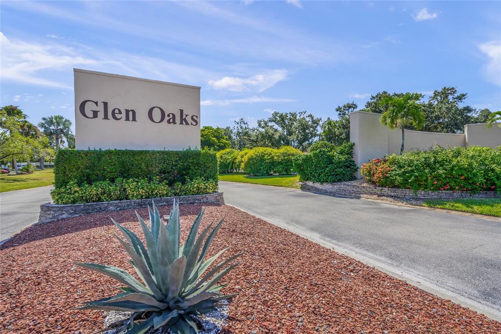 A sign reading Glen Oaks stands at the entrance of a residential community — 1325 GLEN OAKS DRIVE E UNIT 133, SARASOTA, FL