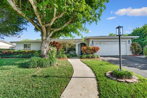 A single-story house with a white exterior, a large tree, and a paved walkway — 14544 SW 76th St, Miami FL 33183, MIAMI, FL