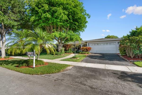 A single-story house with a white garage door, a paved driveway, and mature landscaping — 14544 SW 76th St, Miami FL 33183, MIAMI, FL