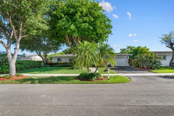A single-story house with a garage is surrounded by a lawn and mature trees — 14544 SW 76th St, Miami FL 33183, MIAMI, FL