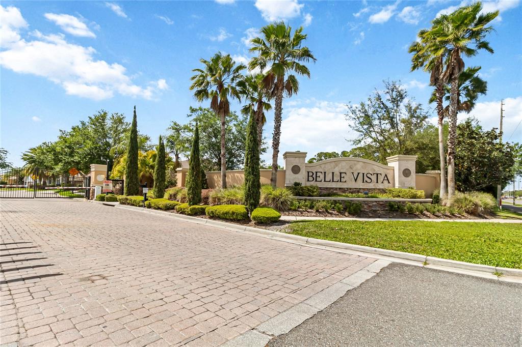 The entrance to the Belle Vista community features a stone sign, palm trees, and gates — 4257 ISLE VISTA AVENUE, BELLE ISLE, FL
