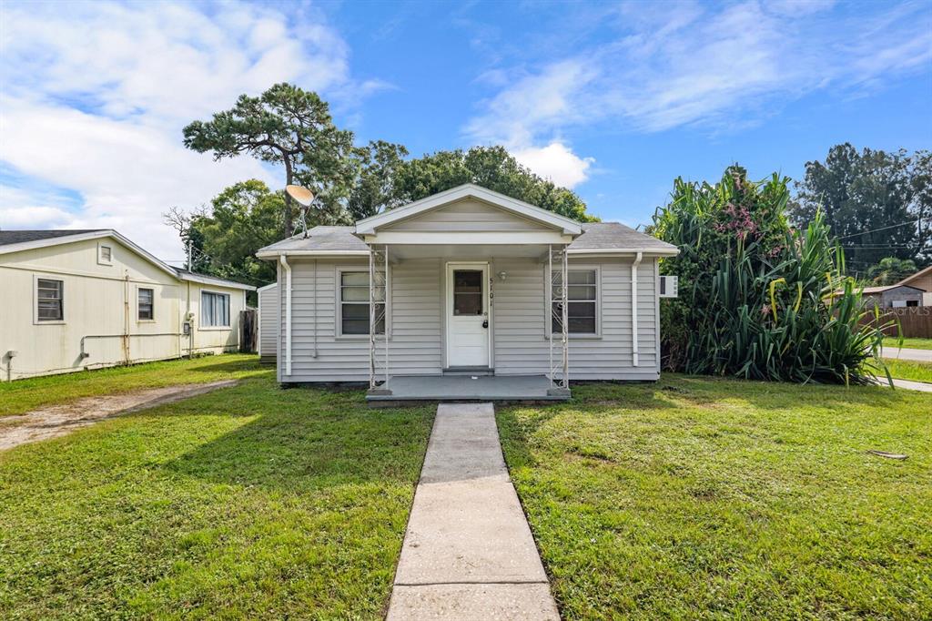 A single-story house with light gray siding, a front porch, and a concrete walkway — 5101 37TH STREET N, ST PETERSBURG, FL