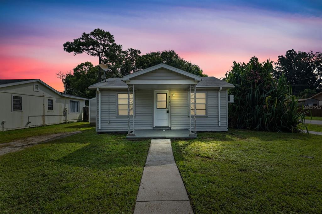 A single-story house with light gray siding and a front porch at sunset — 5101 37TH STREET N, ST PETERSBURG, FL