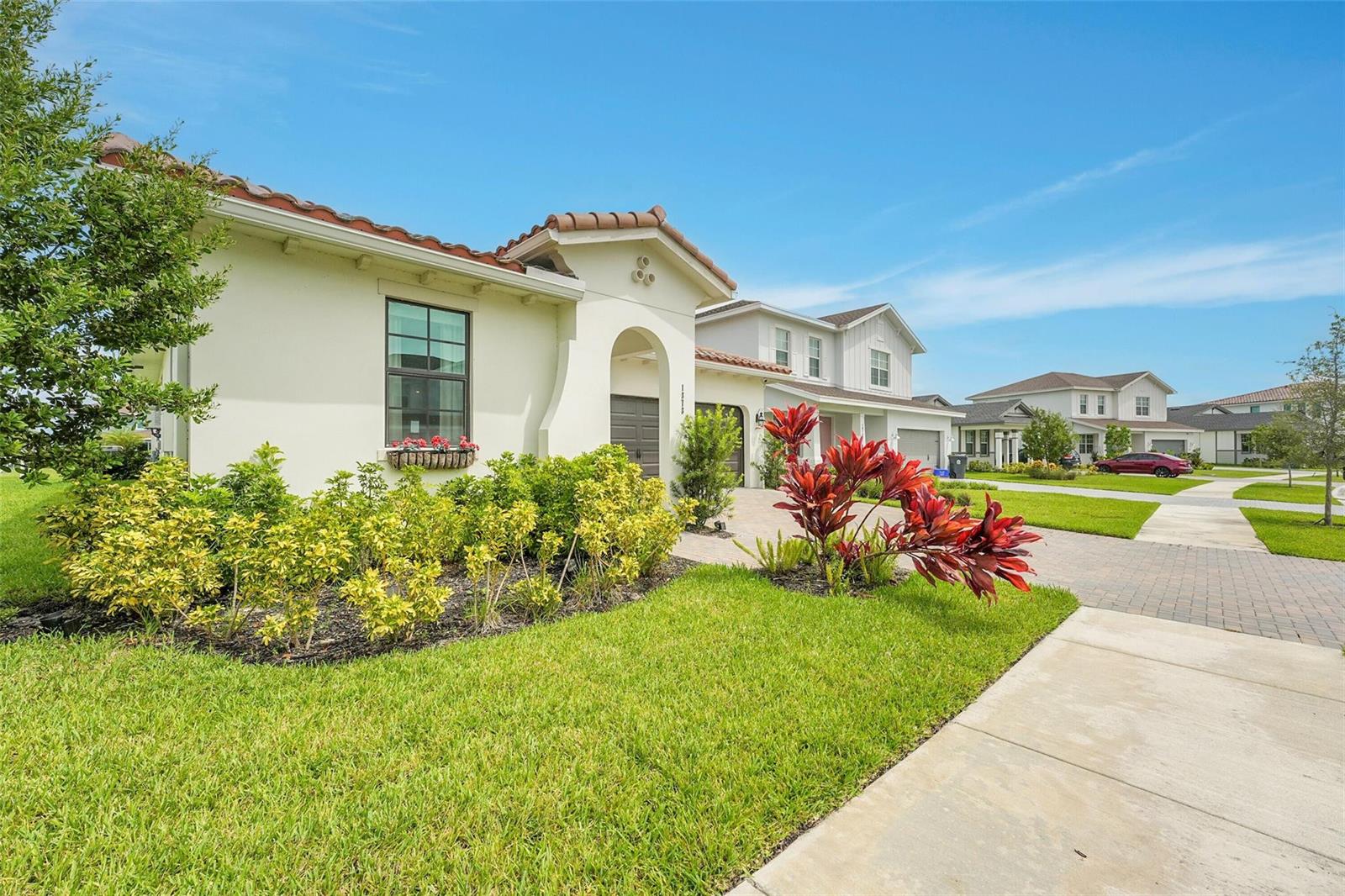 A single-story house with a stucco exterior, tile roof, and landscaped front yard — 1878 Wandering Willow Way, FL 33470, FL