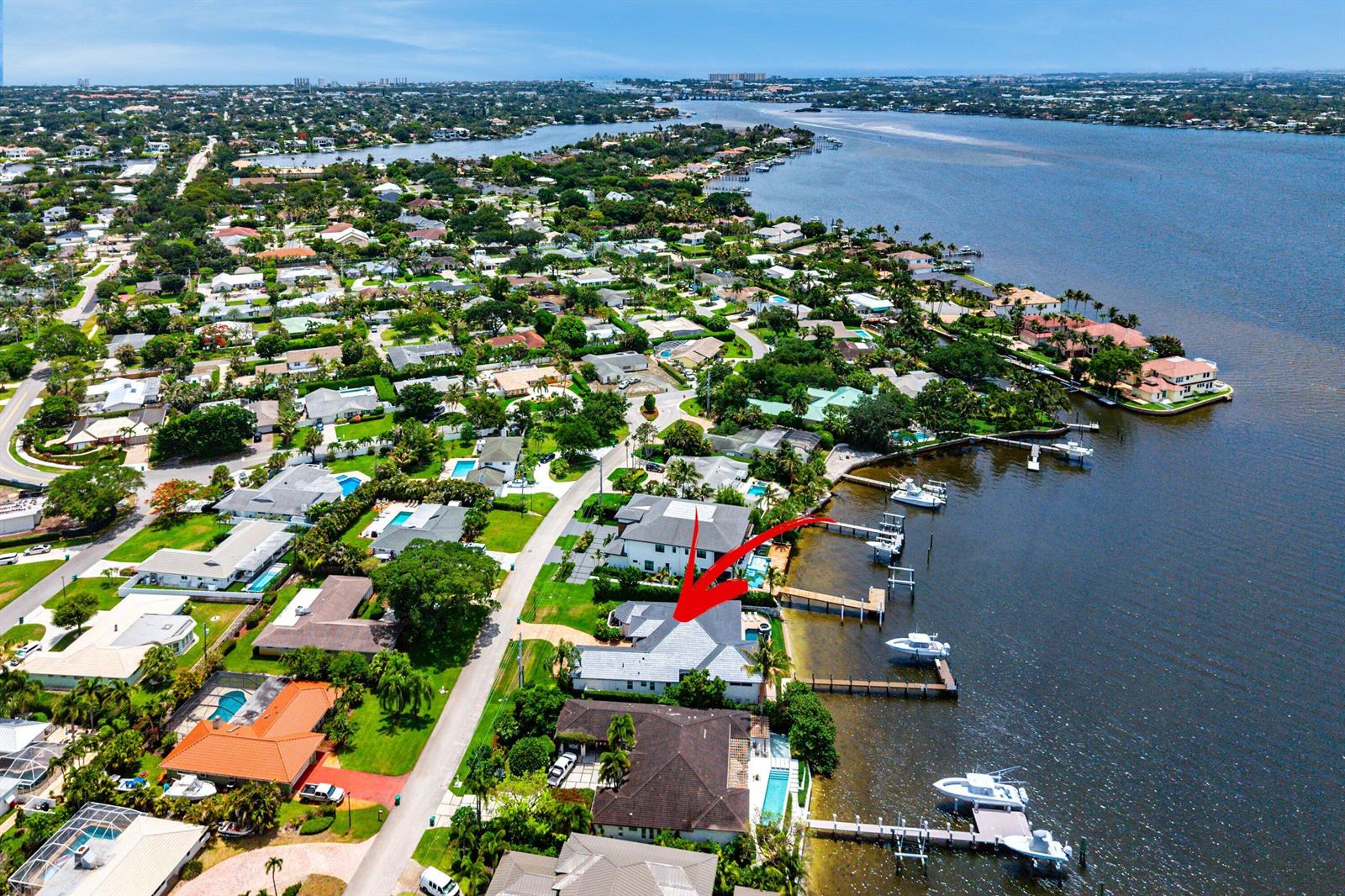 An aerial view shows a waterfront house with a private dock and swimming pool — 47 River Drive, Tequesta FL 33469, TEQUESTA, FL