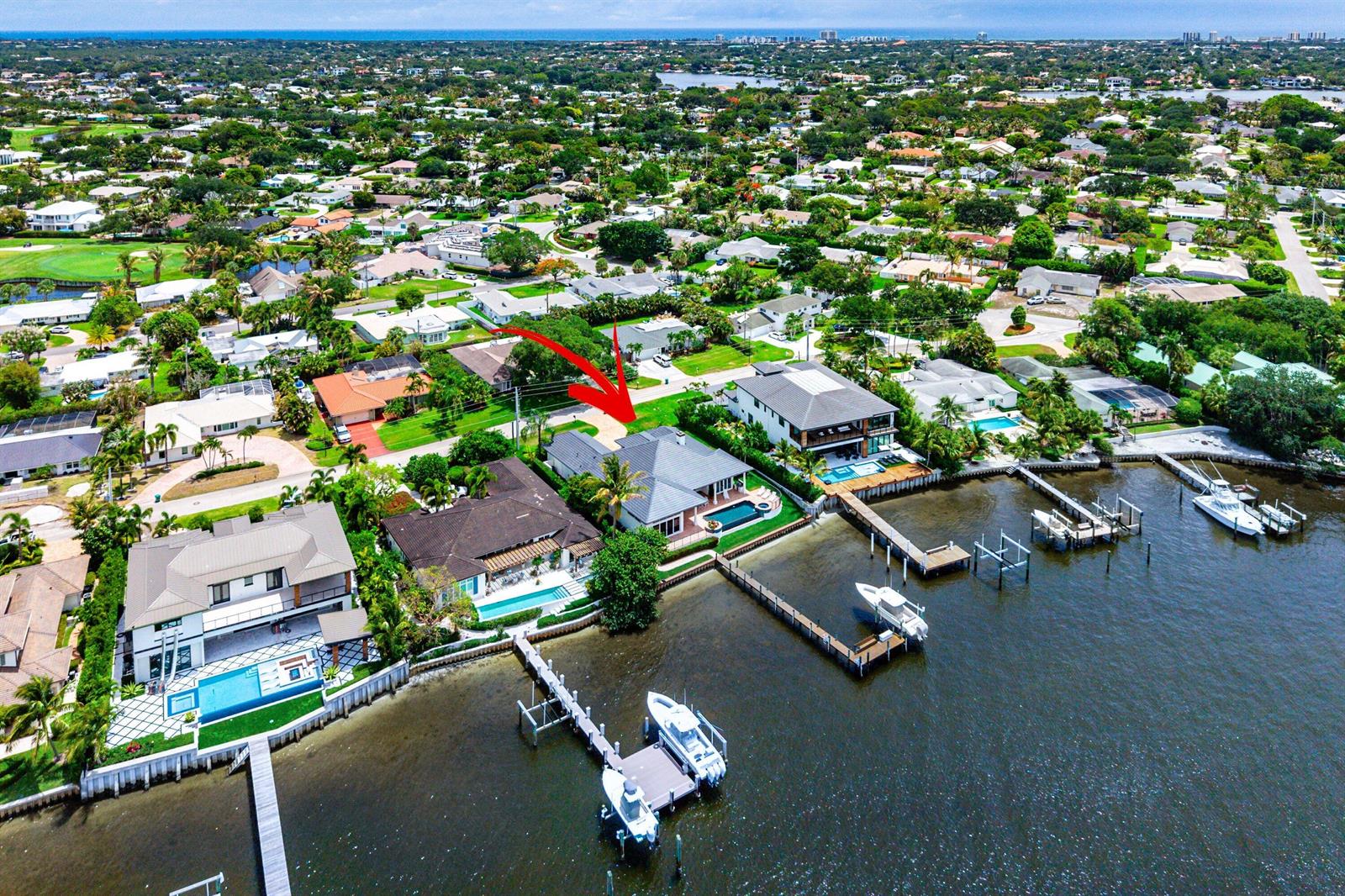 An aerial view of a waterfront house with a swimming pool and private boat dock — 47 River Drive, Tequesta FL 33469, TEQUESTA, FL