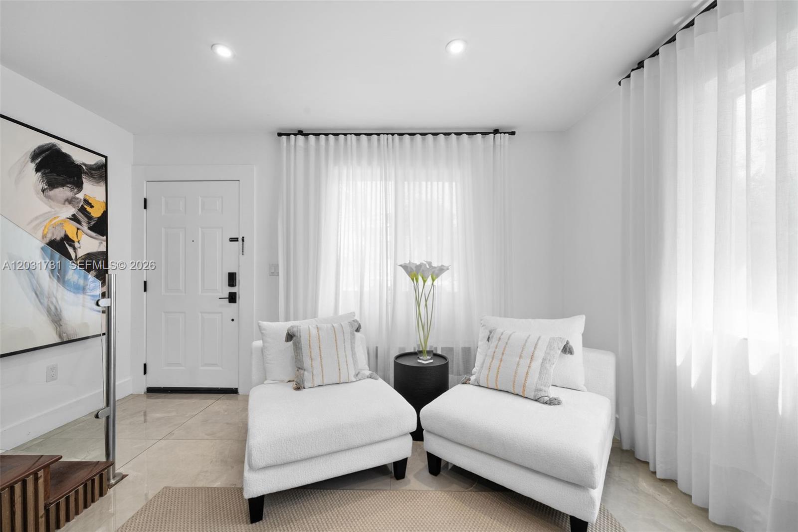 A bright room features two white armchairs, a small side table, and sheer white curtains — 2752 SW 11th St, Miami FL 33135, MIAMI, FL