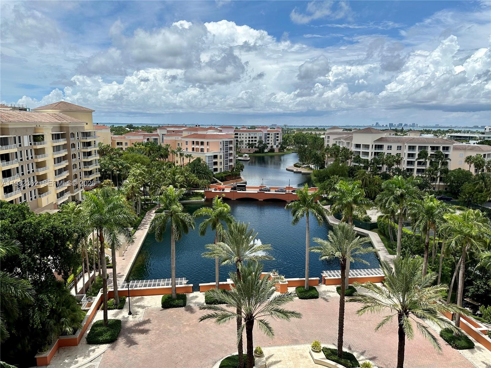 An elevated view shows a courtyard with palm trees, a pond, and surrounding apartment buildings — 785 Crandon Blvd # 803, Key Biscayne FL 33149, KEY BISCAYNE, FL