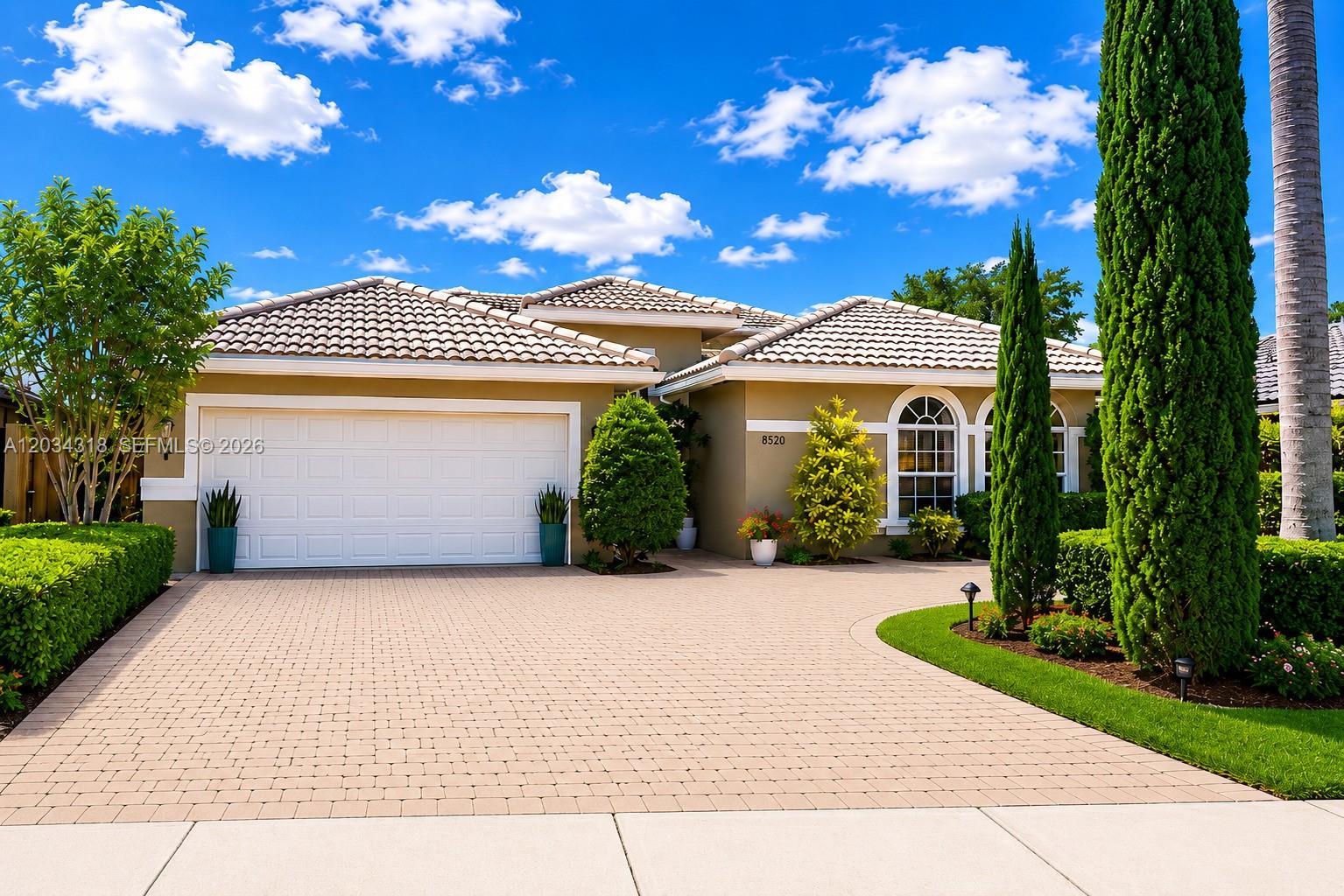A single-story house with a beige exterior, tiled roof, and a paved driveway — 14856 SW 179th St, Miami FL 33187, MIAMI, FL