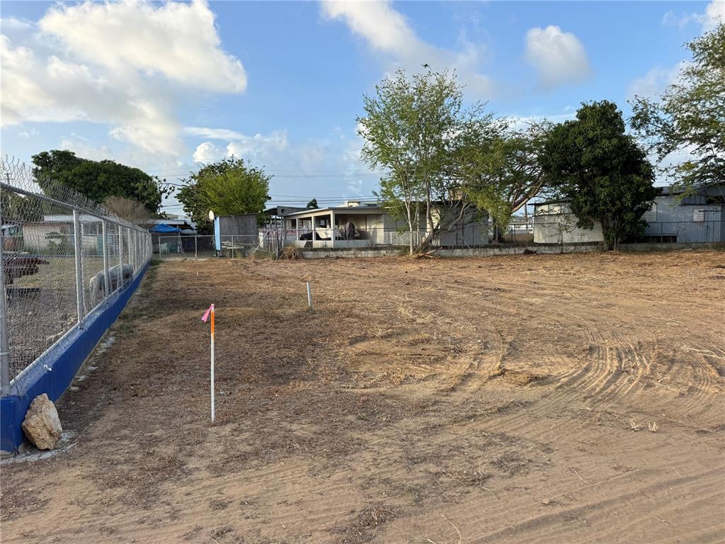 A vacant, cleared dirt lot features survey markers and a chain-link fence on the left — SR 3301 km 0.5 BO BOQUERON EL COMBATE WARD, CABO ROJO, PR