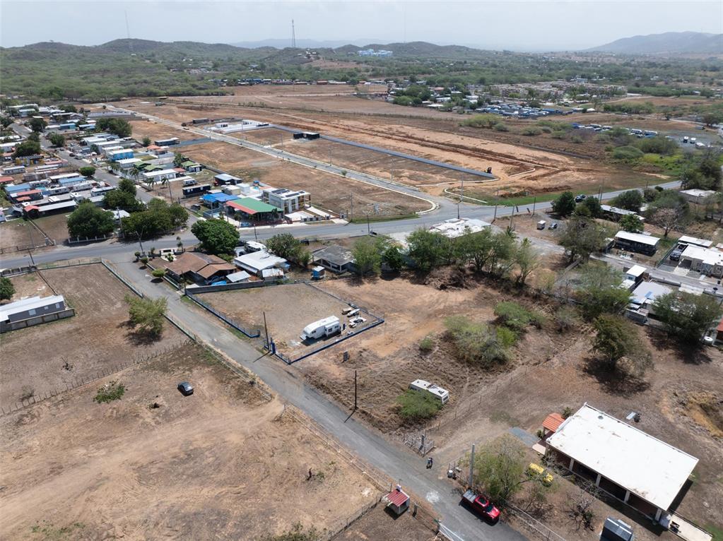 An aerial view shows a vacant, fenced plot of land with a trailer parked inside — SR 3301 km 0.5 BO BOQUERON EL COMBATE WARD, CABO ROJO, PR
