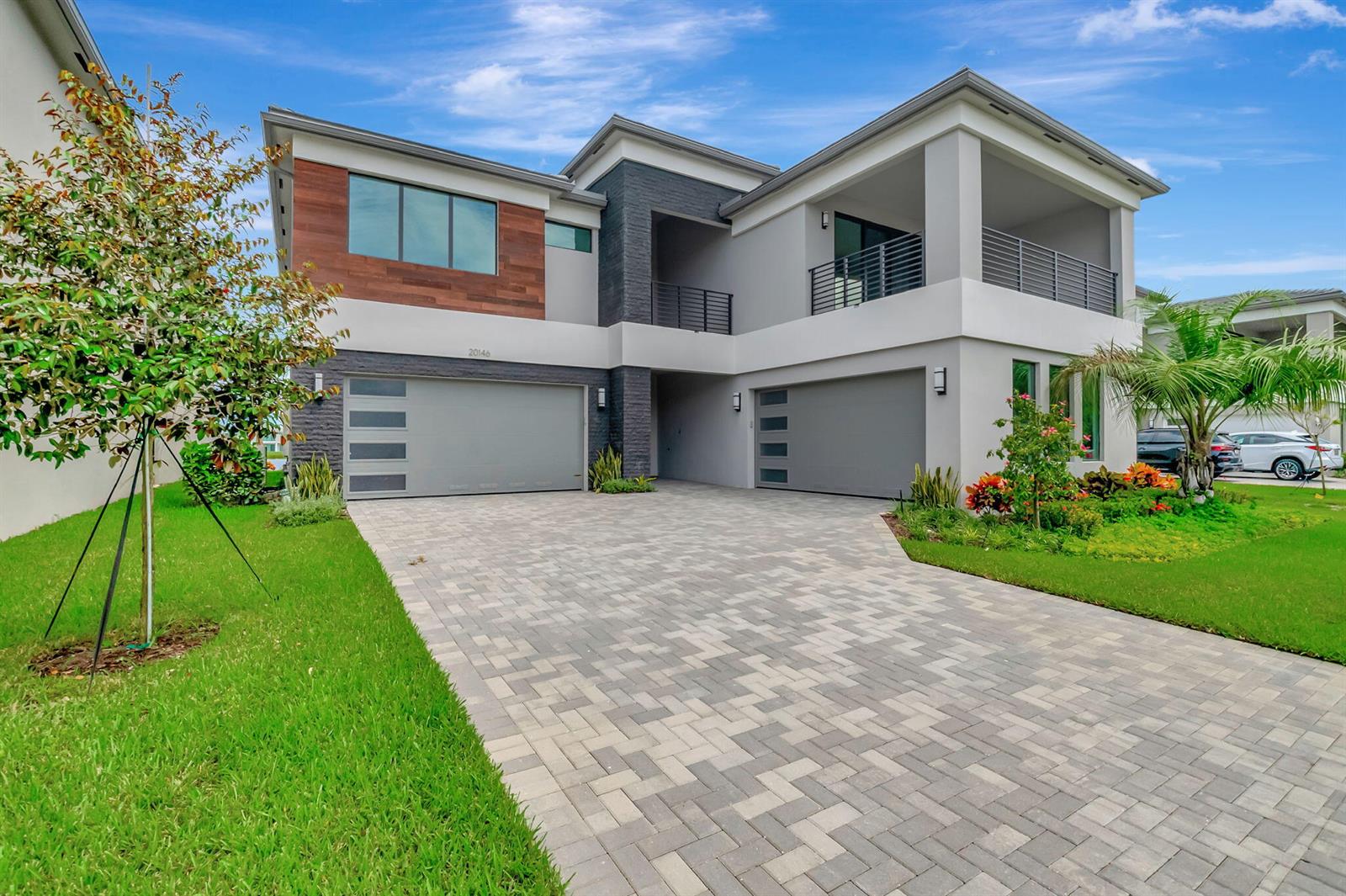 A two-story modern house features a paver driveway, two garages, and a second-floor balcony — 20146 Casa De Campo Lane, Boca Raton FL 33434, BOCA RATON, FL