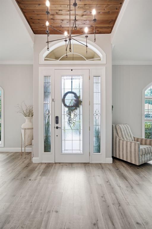 An entryway features a white front door with sidelights, a wood-plank ceiling, and light flooring — 3004 MARBLE CREST DRIVE, LAND O LAKES, FL