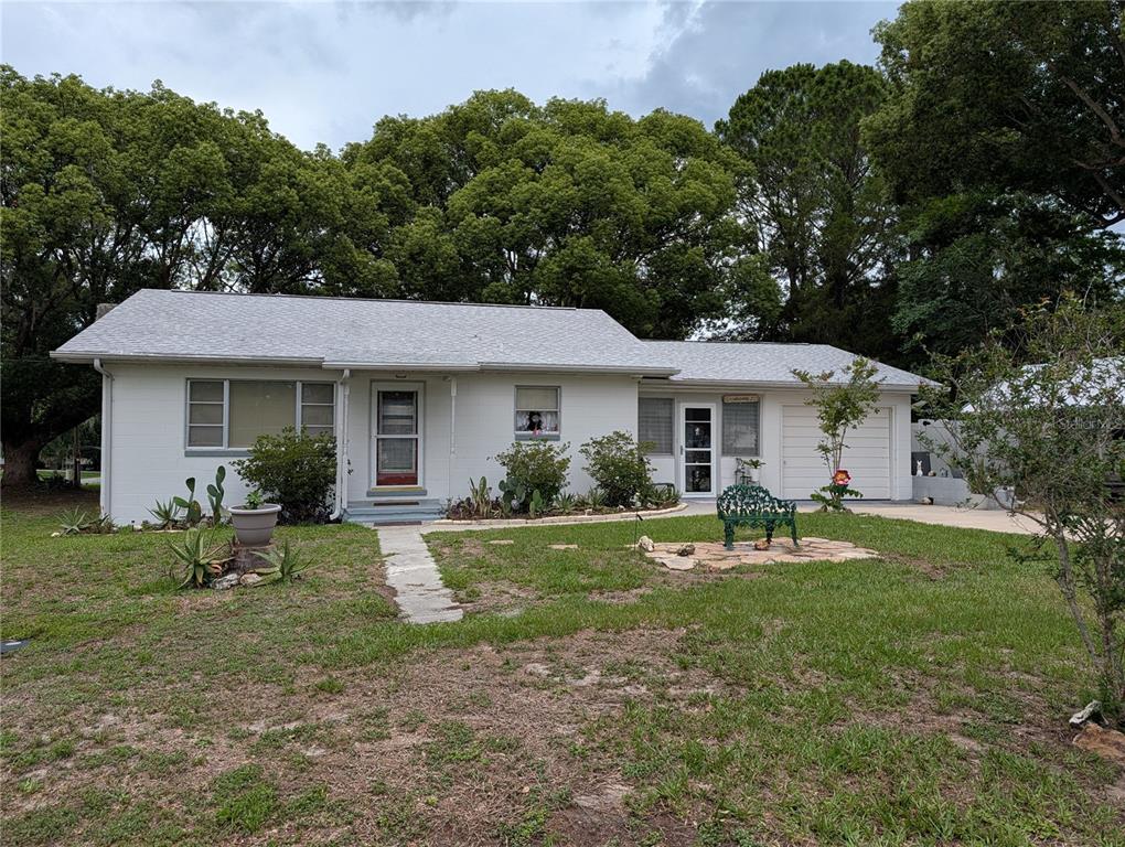 A single-story white house with a gray shingled roof and a front lawn — 11240 SE 53RD COURT, BELLEVIEW, FL
