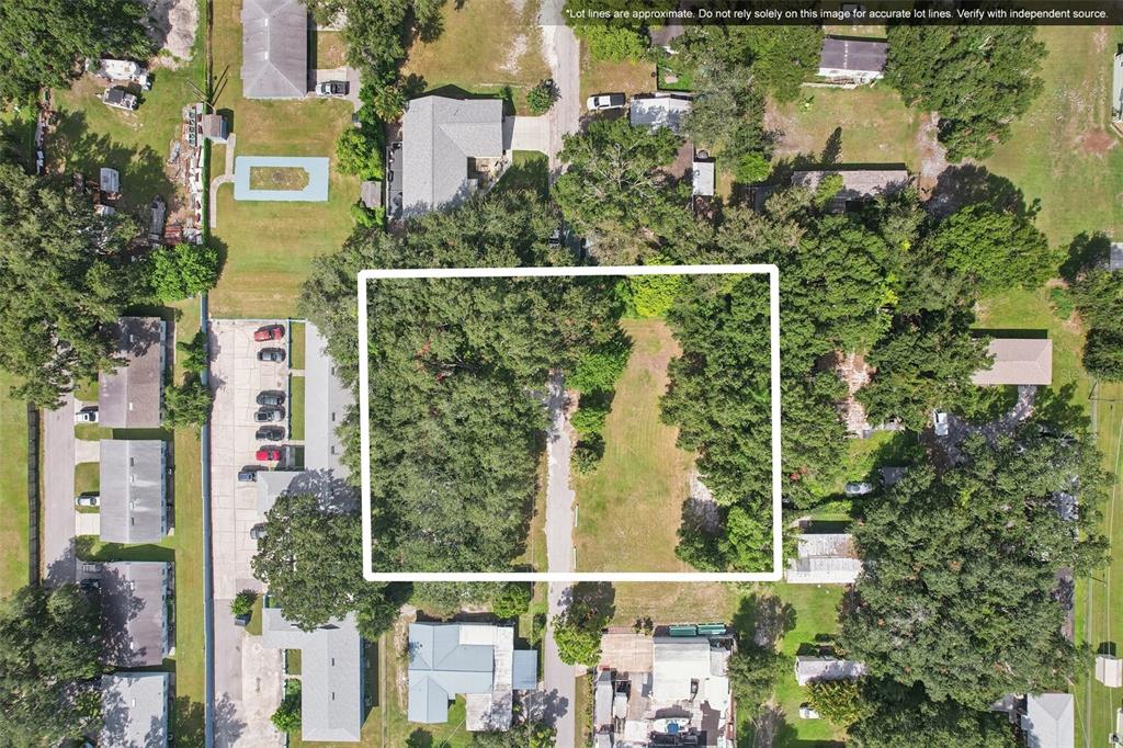An aerial view shows a rectangular lot with trees and a driveway in a neighborhood — 757 LAKE JESSIE DRIVE, WINTER HAVEN, FL