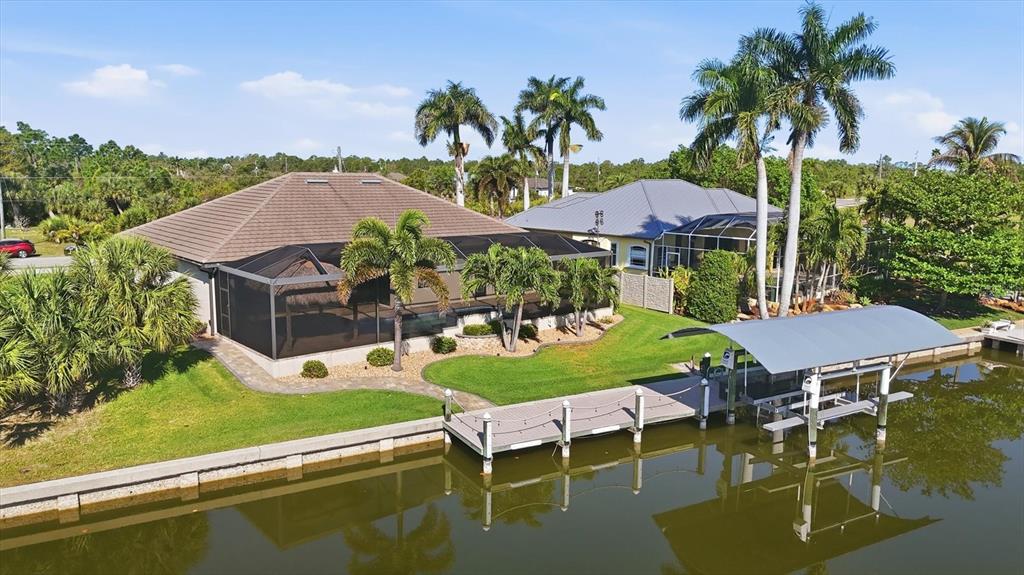 An aerial view of a waterfront house with a screened pool cage and boat dock — 14654 SAN DOMINGO BOULEVARD, PORT CHARLOTTE, FL