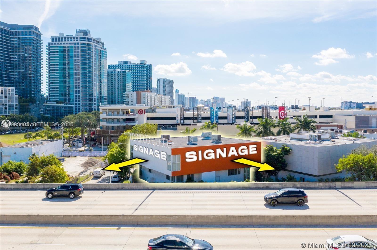 An aerial view shows a commercial building with orange signage panels next to a highway — 3620 NE Miami Pl, Miami FL 33137, MIAMI, FL