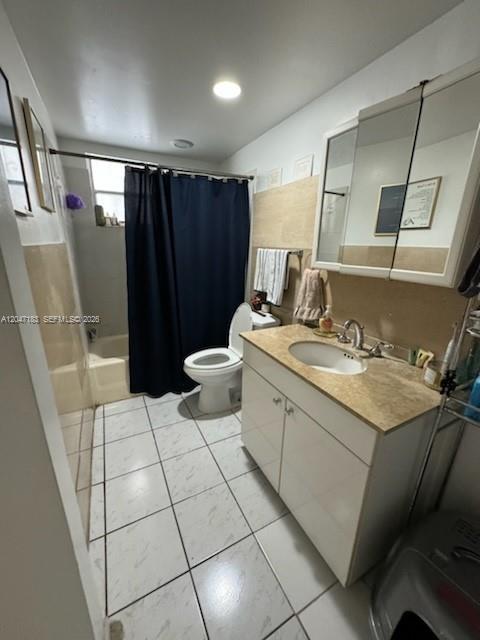 A bathroom with a white vanity, a toilet, and a shower with a dark curtain — 2000 Biarritz Dr # 404, Miami Beach FL 33141, MIAMI BEACH, FL
