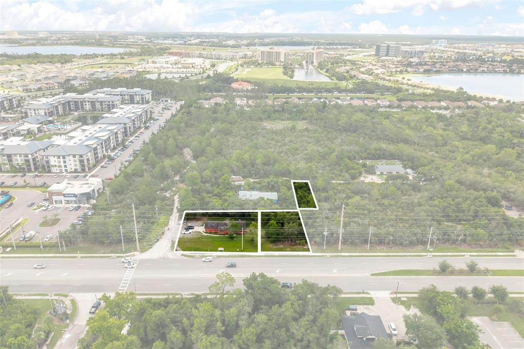 An aerial view shows a property with a house and land outlined in white — 11253 S APOPKA VINELAND ROAD, ORLANDO, FL
