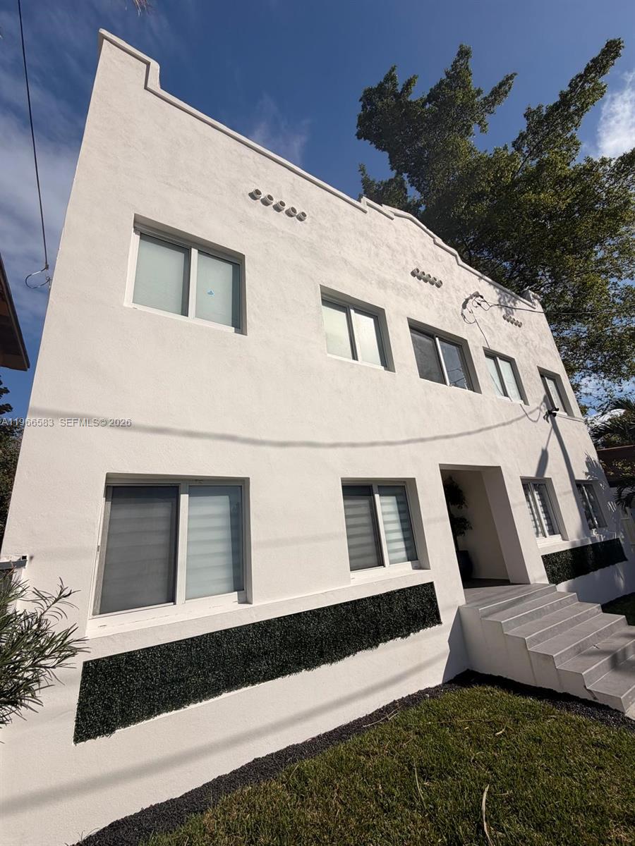 A two-story white stucco building features a stepped roofline and a front entrance with stairs — 337 SW 10th Ave, Miami FL 33130, MIAMI, FL