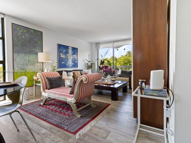 A living room features a striped chaise lounge, a dark wood coffee table, and large artwork — 2501 Brickell Ave # 307, Miami FL 33129, MIAMI, FL