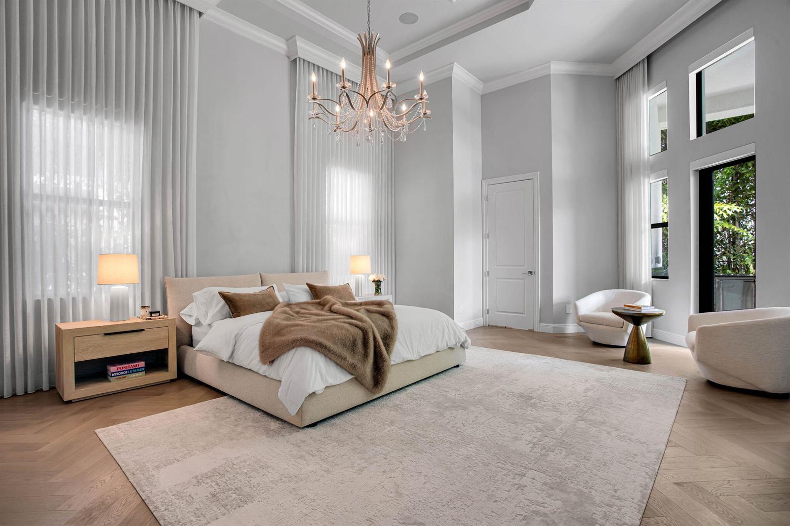 A bright living room features a large white sectional, a coffee table, and floor-to-ceiling windows — 6903 NW 28th Avenue, Boca Raton FL 33496, BOCA RATON, FL