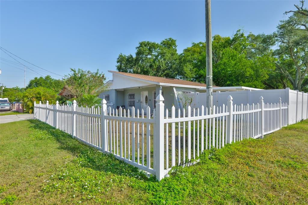 A single-story house with a white picket fence and a covered front porch — 3901 N CLEARFIELD AVENUE, TAMPA, FL