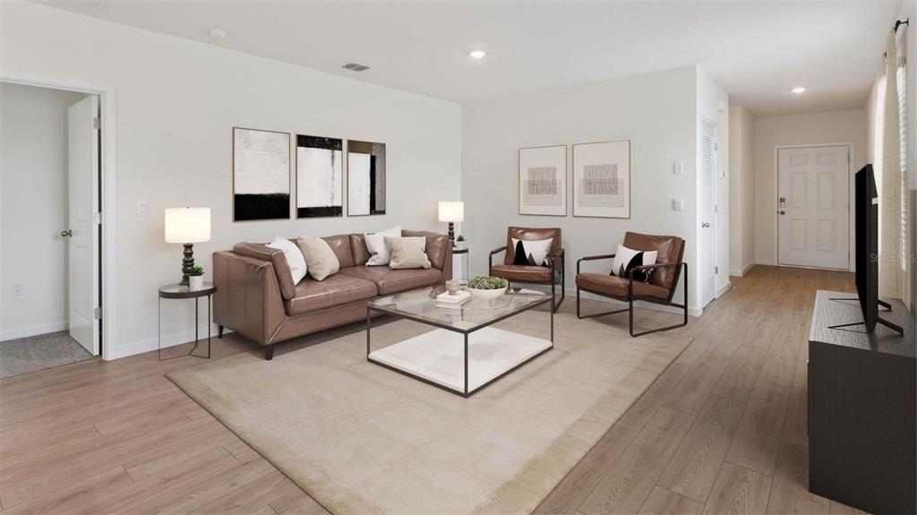 A living room features a brown leather sofa, two armchairs, and a glass coffee table — 5168 BLANKET FLOWER STREET, APOPKA, FL