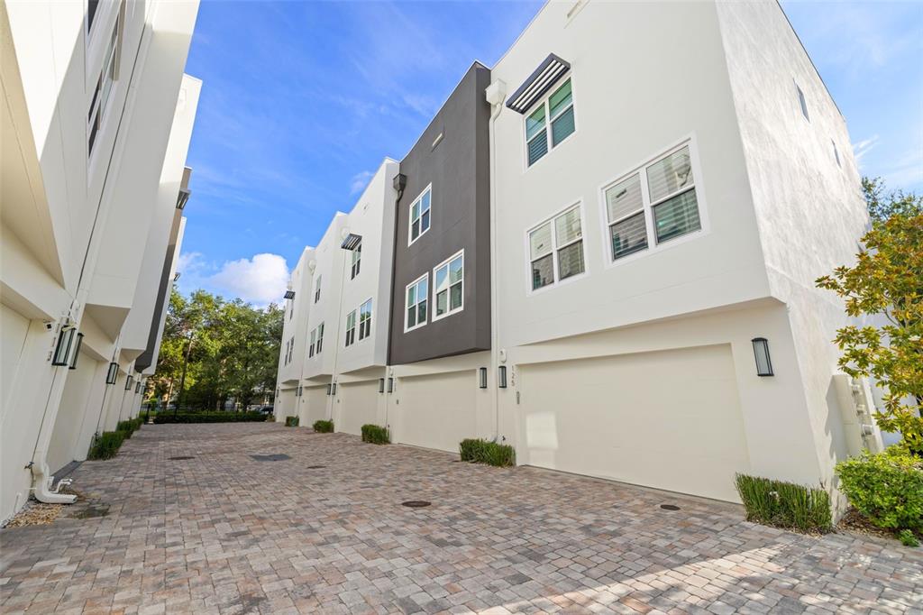 A row of modern townhomes with white and dark gray facades and paved driveways — 123 5TH AVENUE N, ST PETERSBURG, FL